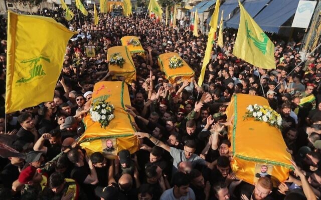 Mourners carry the coffins of five members of the Hezbollah terror group killed in Israeli strikes, during their funeral procession in the southern town of Nabatieh, Lebanon, Nov. 2, 2025. (AP Photo/Mohammad Zaatari, File)