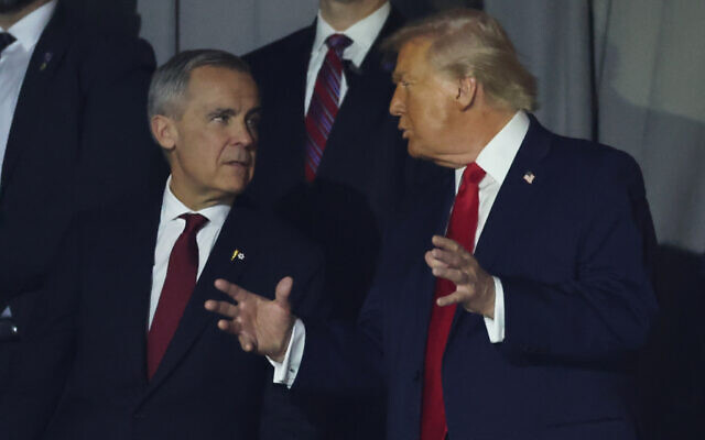 US President Donald Trump talks to Canadian Prime Minister Mark Carney during the draw for the 2026 soccer World Cup at the Kennedy Center in Washington, December 5, 2025. (Dan Mullan/Pool Photo via AP) US President Donald Trump talks to Canadian Prime Minister Mark Carney during the draw for the 2026 soccer World Cup at the Kennedy Center in Washington, December 5, 2025. (Dan Mullan/Pool Photo via AP)