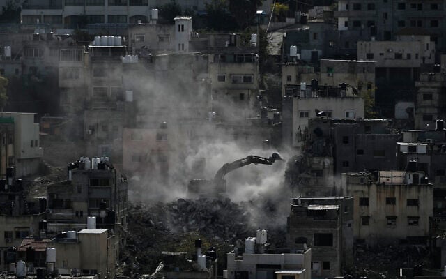 An Israeli army bulldozer demolishes homes in the Palestinian urban refugee camp of Nur Shams, near the West Bank city of Tulkarem, December 31, 2025. (AP/Majdi Mohammed) An Israeli army bulldozer demolishes homes in the Palestinian urban refugee camp of Nur Shams, near the West Bank city of Tulkarem, December 31, 2025. (AP/Majdi Mohammed)