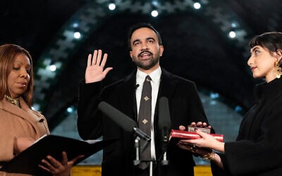 New York State Attorney General Letitia James (left) administers the oath of office to Mayor-elect Zohran Mamdani (center) as his wife Rama Duwaji holds two Qurans, January 1, 2026, in New York. (AP/Yuki Iwamura)