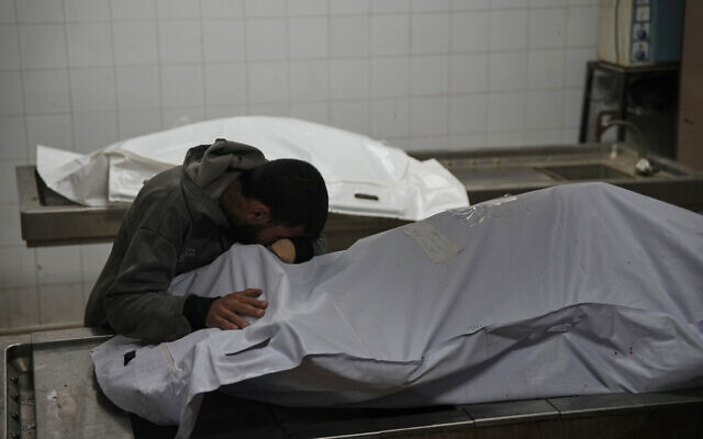 Magdi Abu Al-Khair bids farewell to his mother, Amal Abu Al-Khair, after she and her grandchild, Saud, were killed when their tent caught fire overnight at the Yarmouk displacement camp, at Al-Shifa Hospital in Gaza City, Friday, Jan. 2, 2026. (AP Photo/Jehad Alshrafi) Magdi Abu Al-Khair bids farewell to his mother, Amal Abu Al-Khair, after she and her grandchild, Saud, were killed when their tent caught fire overnight at the Yarmouk displacement camp, at Al-Shifa Hospital in Gaza City, Friday, Jan. 2, 2026. (AP Photo/Jehad Alshrafi)