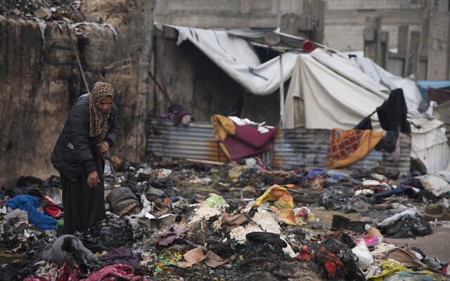 Illustrative: Fatima Abu al-Bayd inspects what remains of her mother's tent after her mother, Amal Abu Al-Khair, and grandchild, Saud, were killed when it caught fire overnight at the Yarmouk displacement camp in Gaza City, January 2, 2026. (AP/Jehad Alshrafi) Illustrative: Fatima Abu al-Bayd inspects what remains of her mother's tent after her mother, Amal Abu Al-Khair, and grandchild, Saud, were killed when it caught fire overnight at the Yarmouk displacement camp in Gaza City, January 2, 2026. (AP/Jehad Alshrafi)