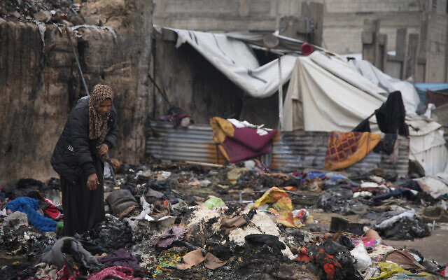 Fatima Abu al-Bayd inspects what remains of her mother's tent after her mother, Amal Abu Al-Khair, and grandchild, Saud, were killed when it caught fire overnight at the Yarmouk displacement camp in Gaza City, Friday, Jan. 2, 2026. (AP Photo/Jehad Alshrafi) Fatima Abu al-Bayd inspects what remains of her mother's tent after her mother, Amal Abu Al-Khair, and grandchild, Saud, were killed when it caught fire overnight at the Yarmouk displacement camp in Gaza City, Friday, Jan. 2, 2026. (AP Photo/Jehad Alshrafi)