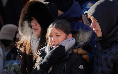 Mourners attend a memorial march in Crans-Montana, Swiss Alps, Switzerland, Jan. 4, 2026, after a devastating fire in Le Constellation bar left dead and injured during the New Year's celebrations. (AP Photo/Baz Ratner)