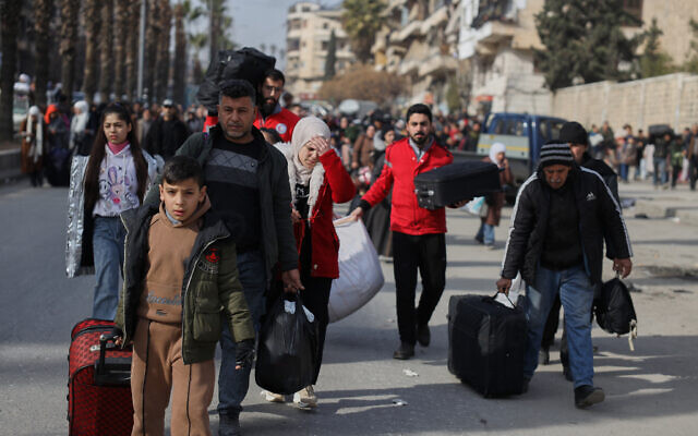 Residents flee the Sheikh Maqsoud and Achrafieh neighborhoods after clashes broke out between Syrian government forces and Kurdish fighters in a contested area of the northern city of Aleppo, Syria, January 7, 2026. (AP/Omar Albam) Residents flee the Sheikh Maqsoud and Achrafieh neighborhoods after clashes broke out between Syrian government forces and Kurdish fighters in a contested area of the northern city of Aleppo, Syria, January 7, 2026. (AP/Omar Albam)