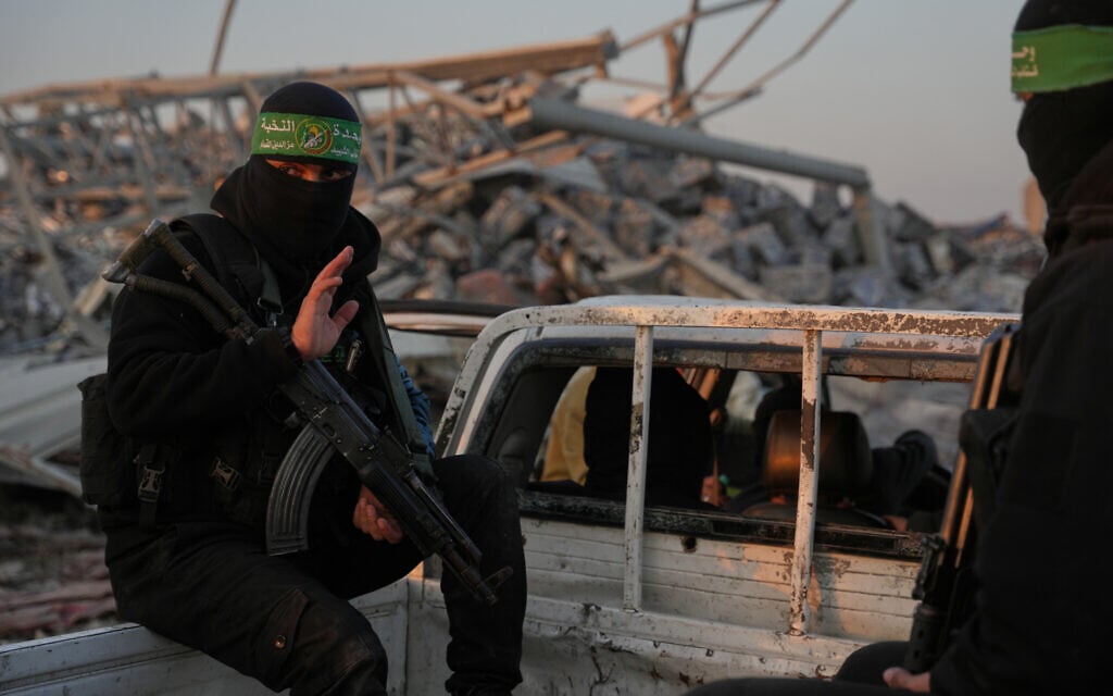 Hamas gunmen search for the remains of Israeli hostage Ran Gvili in the Zeitoun neighborhood of Gaza City, January 7, 2026. (AP/Abdel Kareem Hana) Hamas gunmen search for the remains of Israeli hostage Ran Gvili in the Zeitoun neighborhood of Gaza City, January 7, 2026. (AP/Abdel Kareem Hana)