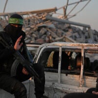 Hamas gunmen search for the remains of Israeli hostage Ran Gvili in the Zeitoun neighborhood of Gaza City, January 7, 2026. (AP/Abdel Kareem Hana)