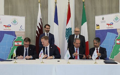Lebanese Prime Minister Nawaf Salam, right background, attends the signing of an international consortium deal for gas exploration between the Lebanese government and representing officials from France's Total, Italy's ENI, and state-owned oil and gas company Qatar Energy, in Beirut, Lebanon, January 9, 2026. (Lebanese Government press office via AP)