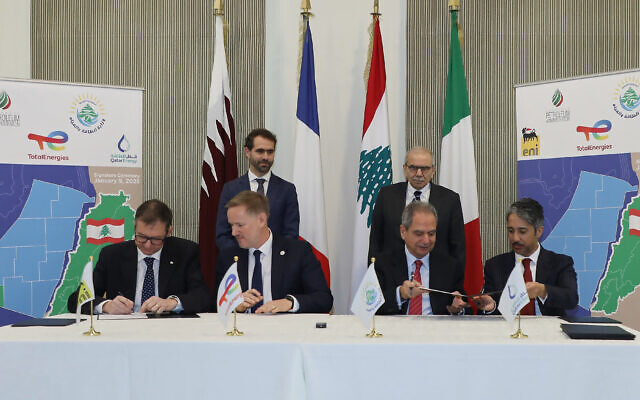 In this photo released by the Lebanese Government press office, Lebanese Prime Minister Nawaf Salam, (back right) attends the signing of an international consortium deal for gas exploration in the coast of southern Lebanon, between the Lebanese government and officials from the international consortium consisting of France's Total, Italy's ENI, and state-owned oil and gas company Qatar Energy, in Beirut, Lebanon, January 9, 2026. (Lebanese Government press office via AP) In this photo released by the Lebanese Government press office, Lebanese Prime Minister Nawaf Salam, (back right) attends the signing of an international consortium deal for gas exploration in the coast of southern Lebanon, between the Lebanese government and officials from the international consortium consisting of France's Total, Italy's ENI, and state-owned oil and gas company Qatar Energy, in Beirut, Lebanon, January 9, 2026. (Lebanese Government press office via AP)