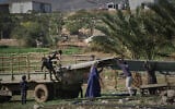 Palestinian residents of Ras Ein al-Auja village in the West Bank pack up their belongings and prepare to leave their homes after deciding to flee mounting settler violence, January 11, 2026. (AP/Mahmoud Illean)
