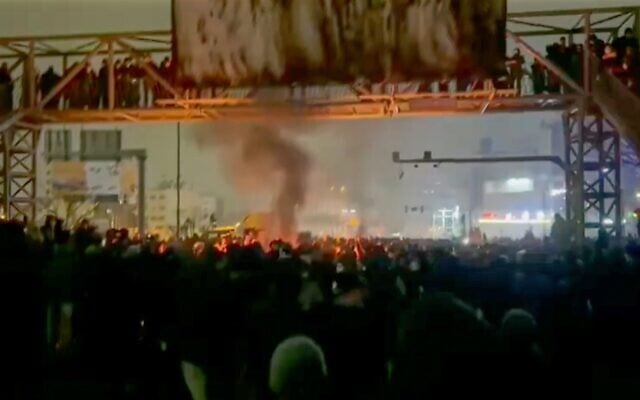 In this frame grab from footage circulating on social media from Iran shows protesters taking to the streets in Tehran, Iran, January 9, 2026. (UGC via AP)