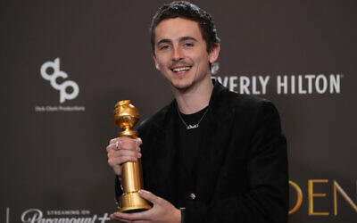 Timothée Chalamet poses with the award for best performance by a male actor in a motion picture – musical or comedy for 'Marty Supreme' during the 83rd Golden Globes on January 11, 2026, at the Beverly Hilton in Beverly Hills, California. (AP/Chris Pizzello)