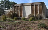 Boards cover the charred remains of the Beth Israel Congregation library, in Jackson, Mississippi, January 12, 2026. (AP Photo / Sophie Bates)