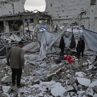 People inspect the site where at least three Palestinians died following the collapse of walls onto tents sheltering displaced people in Gaza City amid rainfall and strong winds, Tuesday, Jan. 13, 2026. (AP Photo/Jehad Alshrafi)