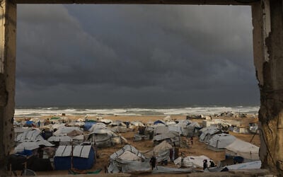 A view of a displacement camp sheltering Palestinians on a beach amid stormy weather in Gaza City, January 13, 2026. (AP/Jehad Alshrafi)