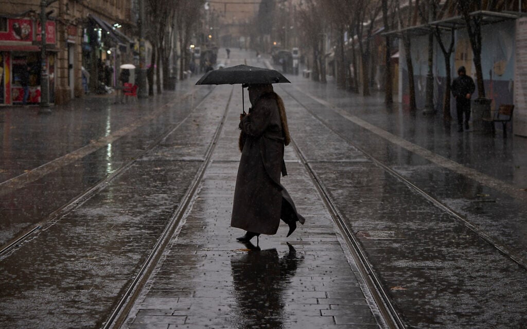 A woman walks in downtown Jerusalem during rainfall, Tuesday, Jan. 13, 2026. (AP Photo/Ohad Zwigenberg) A woman walks in downtown Jerusalem during rainfall, Tuesday, Jan. 13, 2026. (AP Photo/Ohad Zwigenberg)