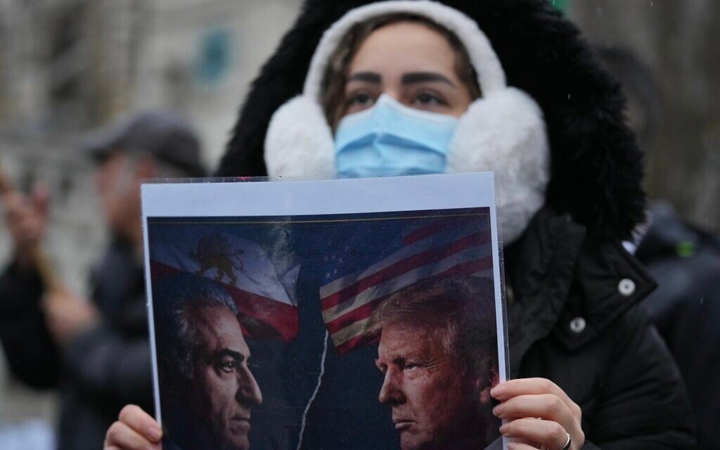 A protester holds up a poster showing Iran’s exiled crown prince Reza Pahlavi, left, and US President Donald Trump, right, as she demonstrates outside the Houses of Parliament, in London, England, January 13, 2026. (AP Photo/Kin Cheung) A protester holds up a poster showing Iran’s exiled crown prince Reza Pahlavi, left, and US President Donald Trump, right, as she demonstrates outside the Houses of Parliament, in London, England, January 13, 2026. (AP Photo/Kin Cheung)