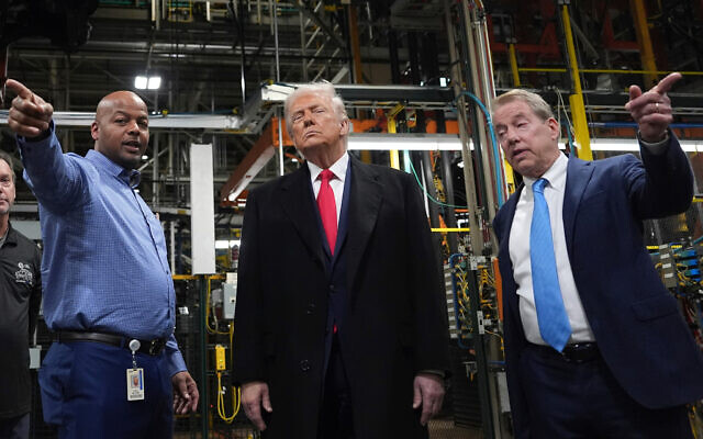 US President Donald Trump listens to Corey Williams, Ford River Rouge Plant Manager, left, and Bill Ford, Executive Chairman of Ford, during a tour of the Ford River Rogue complex, January 13, 2026, in Dearborn, Mich. (AP Photo/Evan Vucci) US President Donald Trump listens to Corey Williams, Ford River Rouge Plant Manager, left, and Bill Ford, Executive Chairman of Ford, during a tour of the Ford River Rogue complex, January 13, 2026, in Dearborn, Mich. (AP Photo/Evan Vucci)