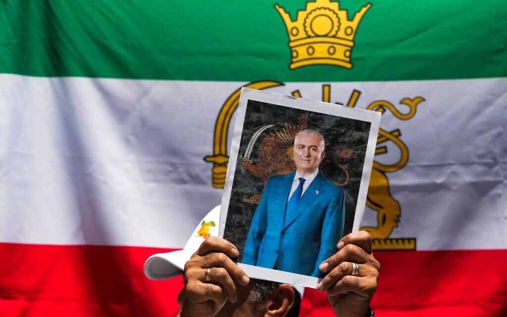 A protester holds a poster of Iran's exiled crown prince Reza Pahlavi during a rally in support of anti-government protests in Iran, outside Iran's embassy in Santiago, Chile, January 13, 2026. (AP/Esteban Felix) A protester holds a poster of Iran's exiled crown prince Reza Pahlavi during a rally in support of anti-government protests in Iran, outside Iran's embassy in Santiago, Chile, January 13, 2026. (AP/Esteban Felix)