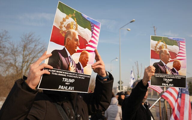 Members of the Iranian community hold posters of Iran's exiled crown prince Reza Pahlavi and US President Donald Trump during a rally in support of anti-government protests in Iran, outside the US Embassy in Bucharest, Romania, January 14, 2026. (AP/Andreea Alexandru)