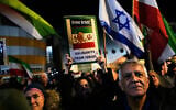 Demonstrators wave Israeli flag and pre-revolution Iran flag during a rally in support of Iran's anti-government protests, in Holon, Israel on January 14, 2026. (AP Photo/Ohad Zwigenberg)