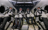 Roscosmos cosmonaut Oleg Platonov, left, NASA astronauts Mike Fincke, Zena Cardman, and JAXA (Japan Aerospace Exploration Agency) astronaut Kimiya Yui are seen inside the SpaceX Dragon Endeavour spacecraft onboard the SpaceX recovery ship SHANNON shortly after having landed in the Pacific Ocean off the coast of Long Beach, Calif., Thursday, Jan. 15, 2026. (NASA via AP)