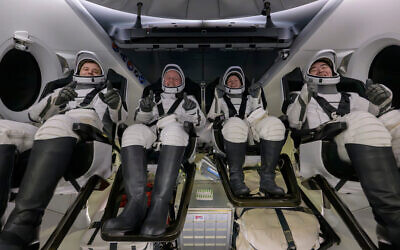 Roscosmos cosmonaut Oleg Platonov, left, NASA astronauts Mike Fincke, Zena Cardman, and JAXA (Japan Aerospace Exploration Agency) astronaut Kimiya Yui are seen inside the SpaceX Dragon Endeavour spacecraft onboard the SpaceX recovery ship SHANNON shortly after having landed in the Pacific Ocean off the coast of Long Beach, Calif., Thursday, Jan. 15, 2026. (NASA via AP)