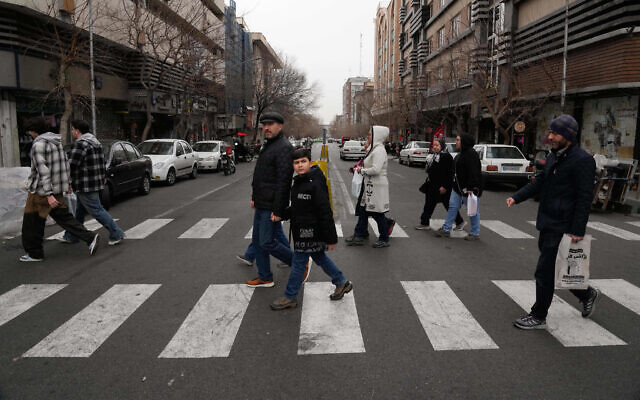 People cross an intersection in downtown Tehran, Iran, Jan. 15, 2026. (AP/Vahid Salemi)
