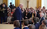 US President Donald Trump carries a hockey stick as he departs an event to honor the 2025 Stanley Cup Champion Florida Panthers in the East Room of the White House on January 15, 2026, in Washington. (AP/Evan Vucci)