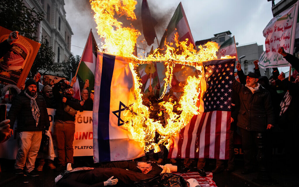 People burn US and Israeli flags during a rally in support of the Iranian government, in Istanbul, Turkey, Jan. 18, 2026. (AP/Emrah Gurel)