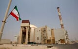 An Iranian flag flutters in front of the reactor building of the Bushehr nuclear power plant, just outside the southern city of Bushehr, Iran, Aug. 21, 2010. (AP/Vahid Salemi, File)