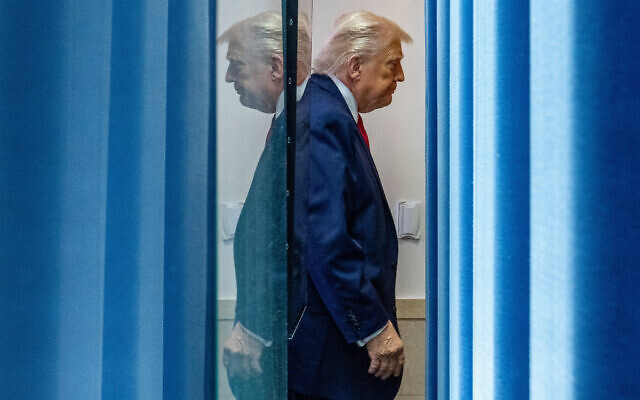 US President Donald Trump departs after speaking with reporters in the James Brady Press Briefing Room at the White House, January 20, 2026, in Washington. (AP Photo/Alex Brandon)
