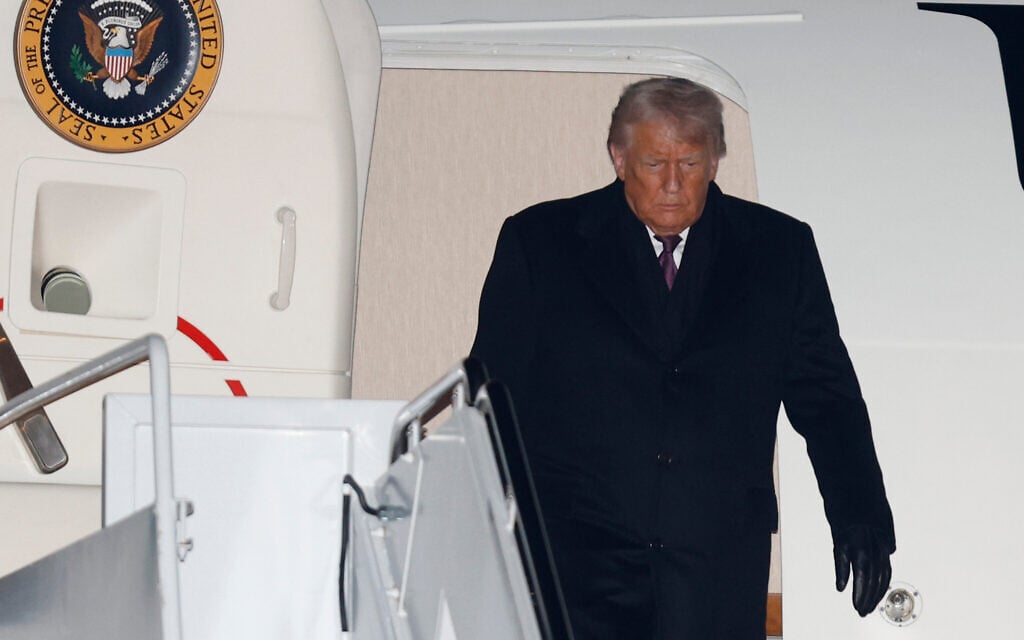 US President Donald Trump arrives on Air Force One at Joint Base Andrews, Maryland, January 22, 2026, after returning from the World Economic Forum in Davos. (AP Photo/Luis M. Alvarez)