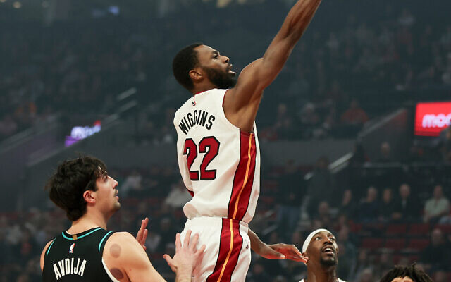 Miami Heat forward Andrew Wiggins (22) drives to the basket past Portland Trail Blazers forward Deni Avdija, left, during the first half of an NBA basketball game, January 22, 2026, in Portland, Oregon. (AP Photo/Amanda Loman)
