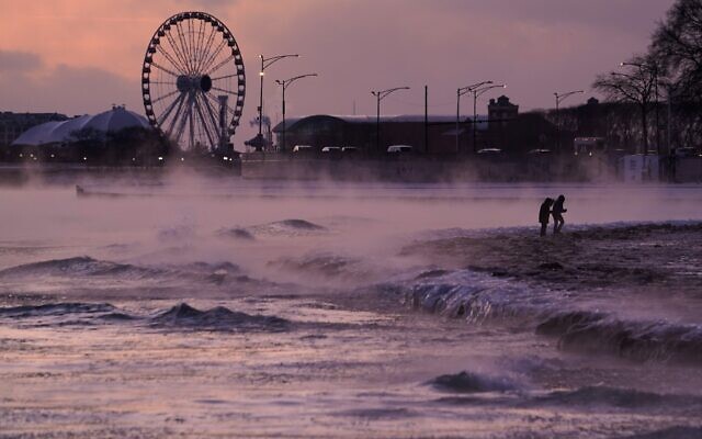 People walk on an ice covered beach along the shore of Lake Michigan, January 23, 2026, in Chicago. (AP Photo/Kiichiro Sato) People walk on an ice covered beach along the shore of Lake Michigan, January 23, 2026, in Chicago. (AP Photo/Kiichiro Sato)