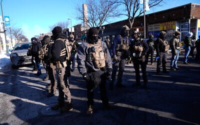 US federal agents stand near the site of a shooting, January 24, 2026, in Minneapolis. (AP Photo/Abbie Parr)