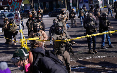 US federal immigration officers deploy pepper spray at observers after a shooting, January 24, 2026, in Minneapolis. (AP Photo/Abbie Parr)