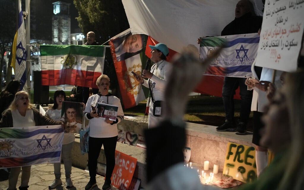 Demonstrators take part in a rally in support of anti-government activists in Iran, as they gather in Holon on January 24, 2026. (AP/Leo Correa)