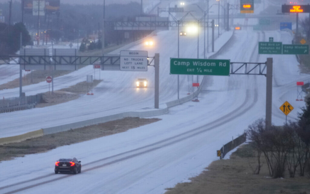 Vehicles move on snow-covered US Highway 67 during a winter storm on January 24, 2026, in Dallas, Texas. (AP/Julio Cortez)