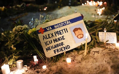 A sign for 37-year-old Alex Pretti, who was fatally shot by a US Border Patrol officer earlier in the day, is displayed during a vigil, January 24, 2026, in Minneapolis, Minnesota. (AP Photo/Adam Gray)