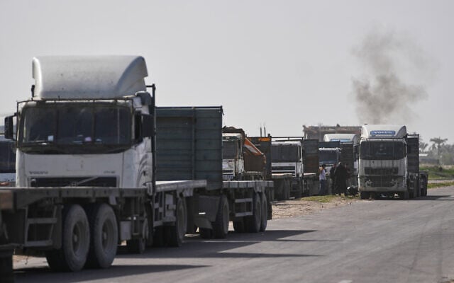 Palestinian commercial trucks are seen parked in an area in Deir al-Balah near the Kissufim crossing in the Gaza Strip as they wait for permission to receive a cargo of goods for sale in the enclave, January 27, 2026. (AP/Abdel Kareem Hana) Palestinian commercial trucks are seen parked in an area in Deir al-Balah near the Kissufim crossing in the Gaza Strip as they wait for permission to receive a cargo of goods for sale in the enclave, January 27, 2026. (AP/Abdel Kareem Hana)