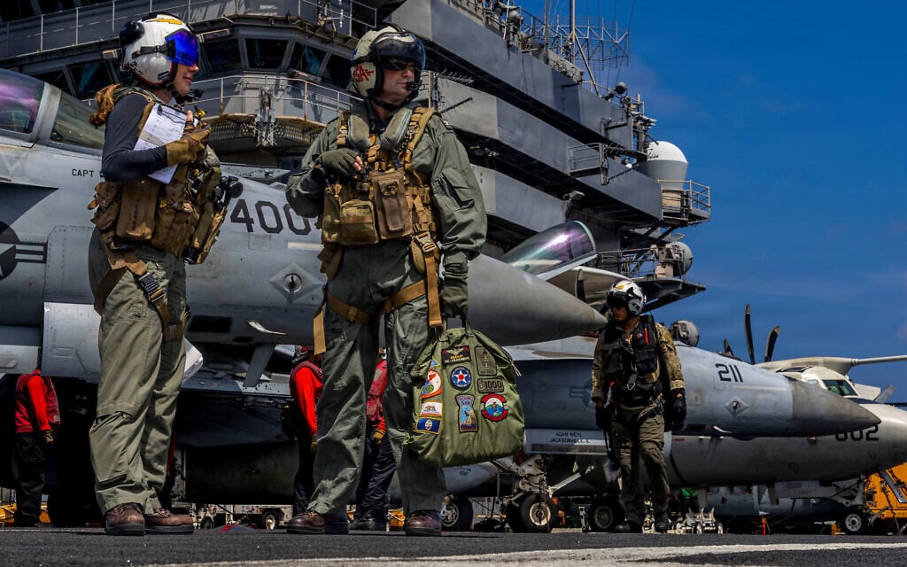 This handout image from the US Navy shows Capt. Daniel Keeler, the commanding officer of the Nimitz-class aircraft carrier USS Abraham Lincoln, as he prepares to fly an MH-60R Sea Hawk helicopter in the Indian Ocean on January 23, 2026. (Mass Communication Specialist Seaman Daniel Kimmelman/US Navy via AP)