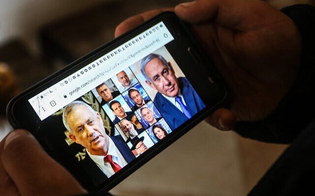 Illustrative: A phone shows the faces of Israeli political figures on March 2, 2020. (Abed Rahim Khatib/ Flash90) Illustrative: A phone shows the faces of Israeli political figures on March 2, 2020. (Abed Rahim Khatib/ Flash90)