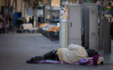 A homeless person in the streets of Jerusalem, December 18, 2024. (Chaim Goldberg/FLASH90)