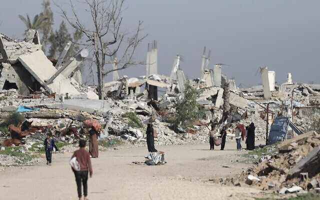 Women and children gather firewood from destroyed homes in the Mughraqa area, January 5, 2026 (Ali Hassan/Flash90)
