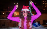 A woman celebrates the new year on New Year’s Eve in Tel Aviv, December 31, 2025. (Avshalom Sassoni/Flash90)