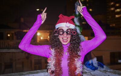 A woman celebrates the new year on New Year’s Eve in Tel Aviv, December 31, 2025. (Avshalom Sassoni/Flash90)