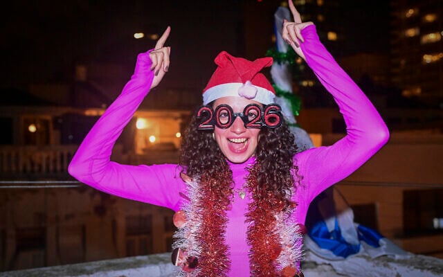 A woman celebrates the new year on New Year’s Eve in Tel Aviv, December 31, 2025. (Avshalom Sassoni/Flash90) A woman celebrates the new year on New Year’s Eve in Tel Aviv, December 31, 2025. (Avshalom Sassoni/Flash90)