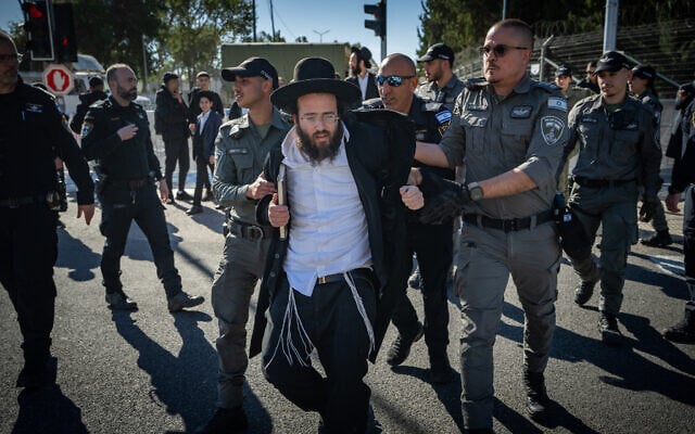 Ultra-Orthodox Jews protest against Haredi conscription outside the IDF Recruitment Center at Tel Hashomer, January 4, 2026. (Erik Marmor/Flash90) Ultra-Orthodox Jews protest against Haredi conscription outside the IDF Recruitment Center at Tel Hashomer, January 4, 2026. (Erik Marmor/Flash90)