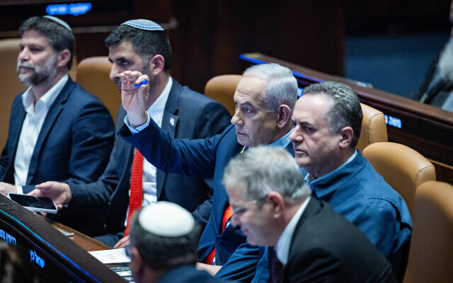 Prime Minister Benjamin Netanyahu seen with ministers and MKs in the Knesset in Jerusalem, on January 5, 2026. (Yonatan Sindel/Flash90)